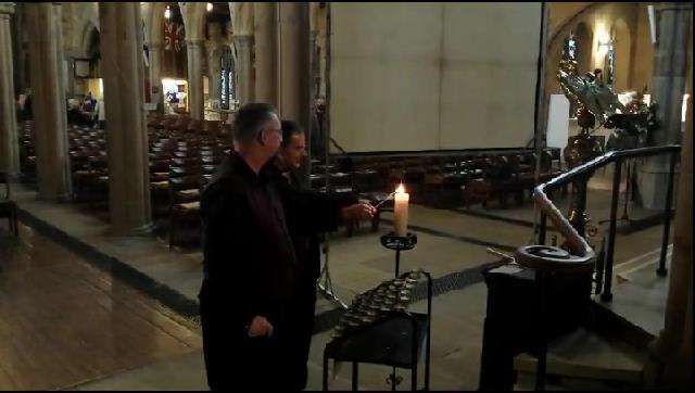 Bishop Toby and Mike Haines light a candle