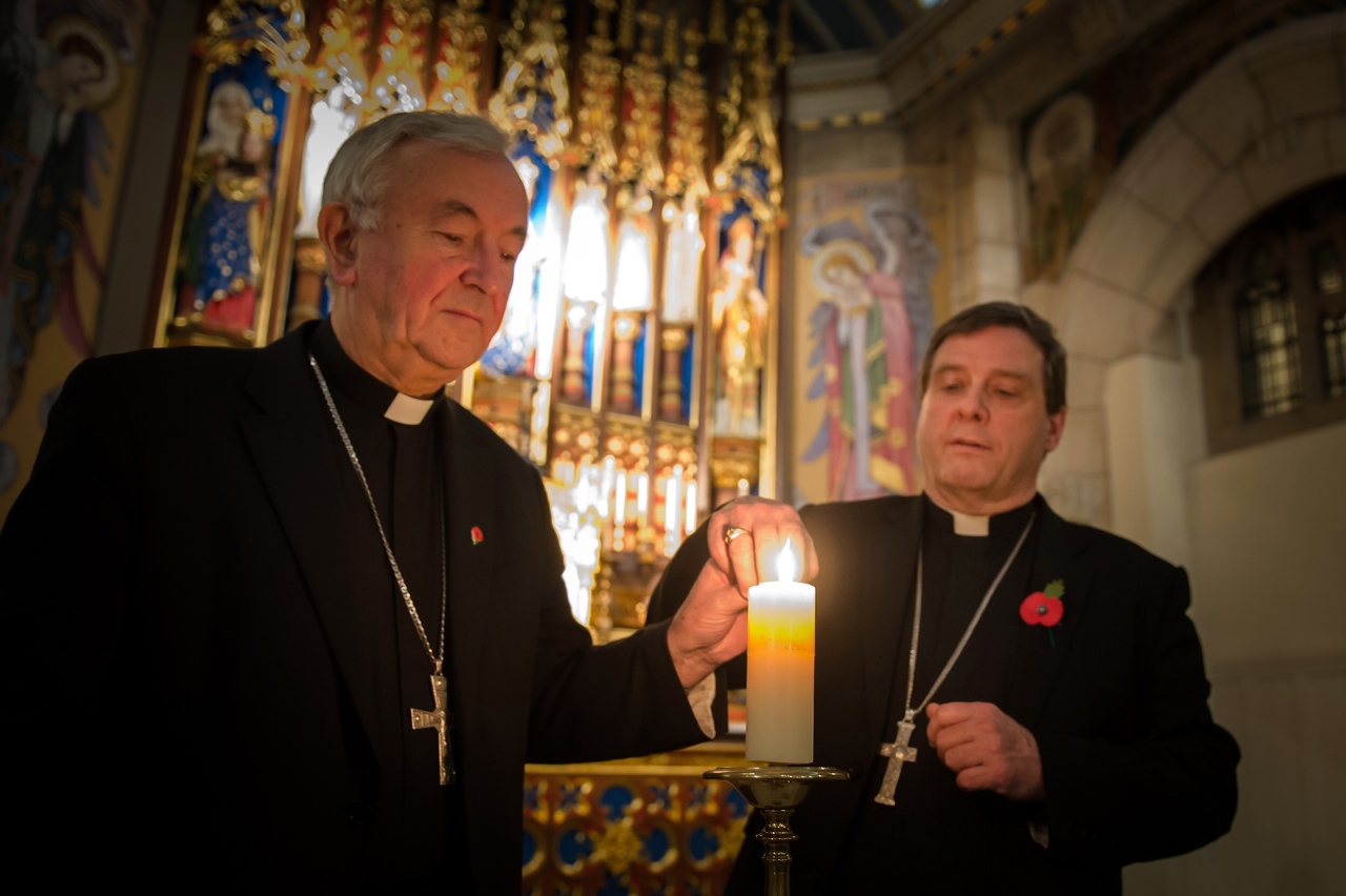 Cardinal Vincent Nichol and Bishop Tony Robinson say prayers together for the Christian couple burned to death in Pakistan 