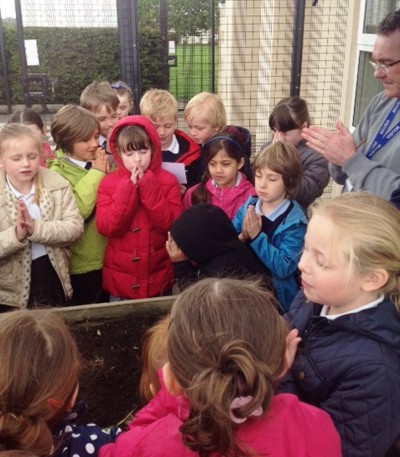 Children pray together as they planted their poppy seeds at St john's Academy Brighouse earlier this year 