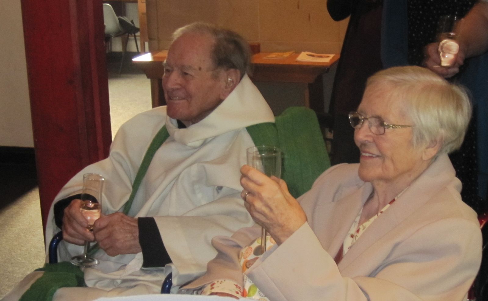 Canon Leslie Chadd enjoys a well deserved glass of bubbly with his wife, Margaret at their double celebration of his 70 years a priest and 60th wedding anniversary 