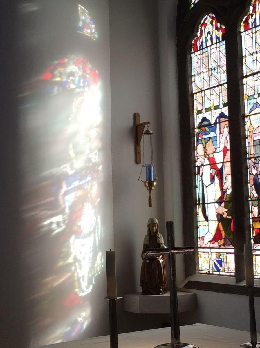 Light creates its own artwork as the sun streams through the stained glass of St Giles' Pontefract