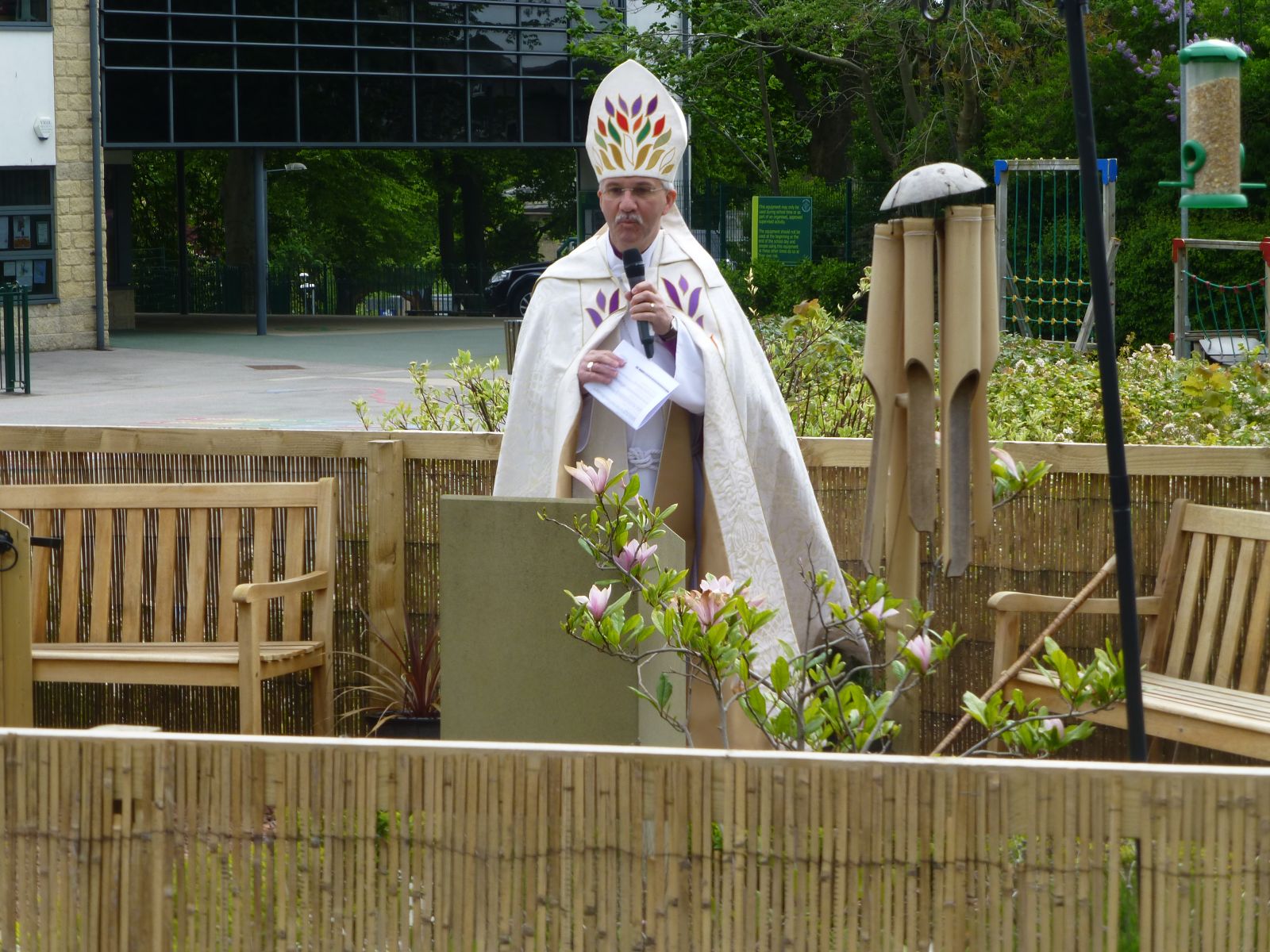 Bishop Jonathan stood in Holy Trinity's reflection garden