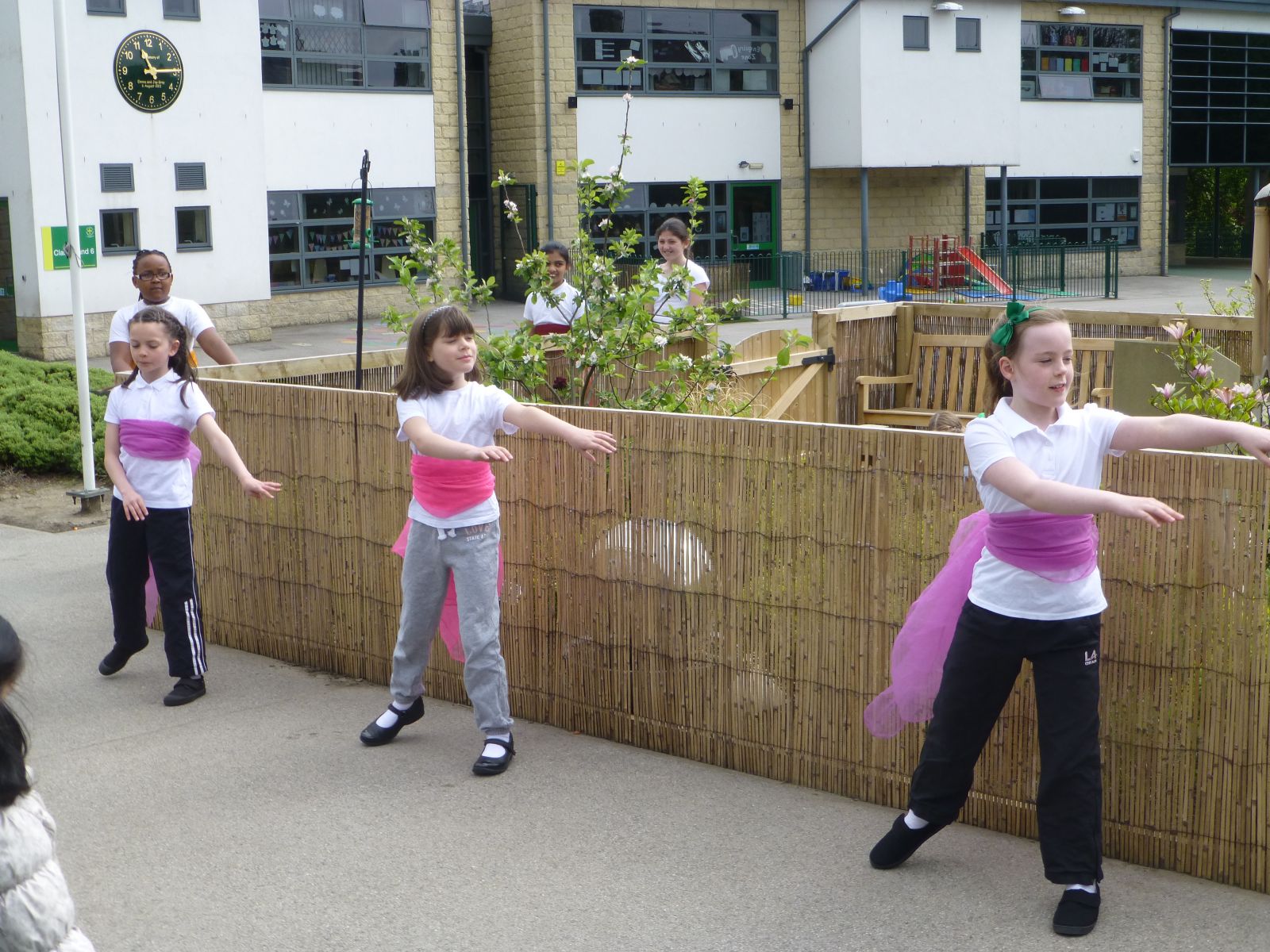 Holy Trinity pupils dancing in front of the reflection garden for the opening ceremony