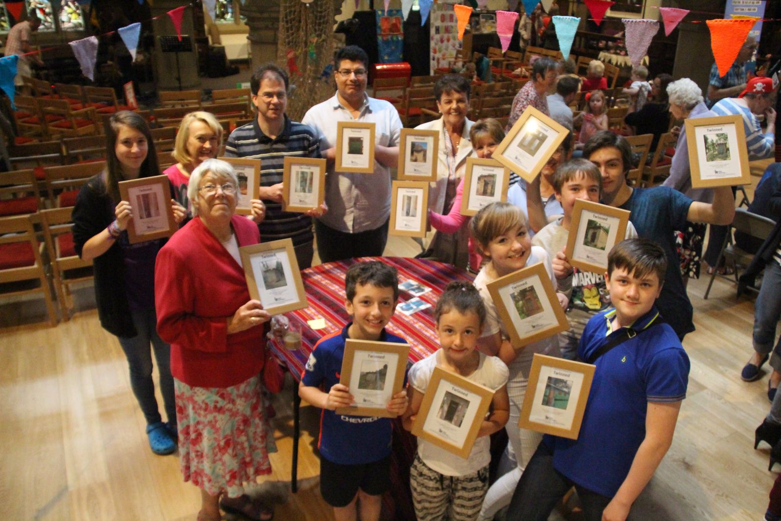 Members of Kirkheaton parish holding up the churches' certificates for the Toilet Twinning