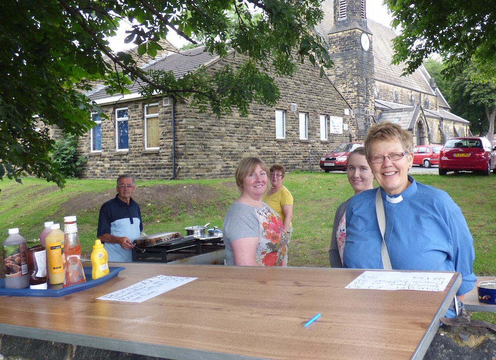 Volunteers with Revd Lindsey Pearson preparing the burgers to be sold at Saturday's football game