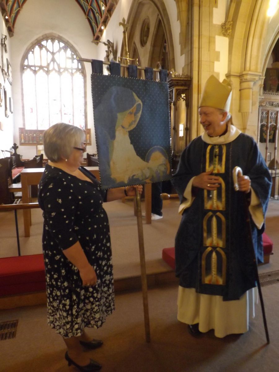 Susan Scrafton and Bishop James with the new MU banner