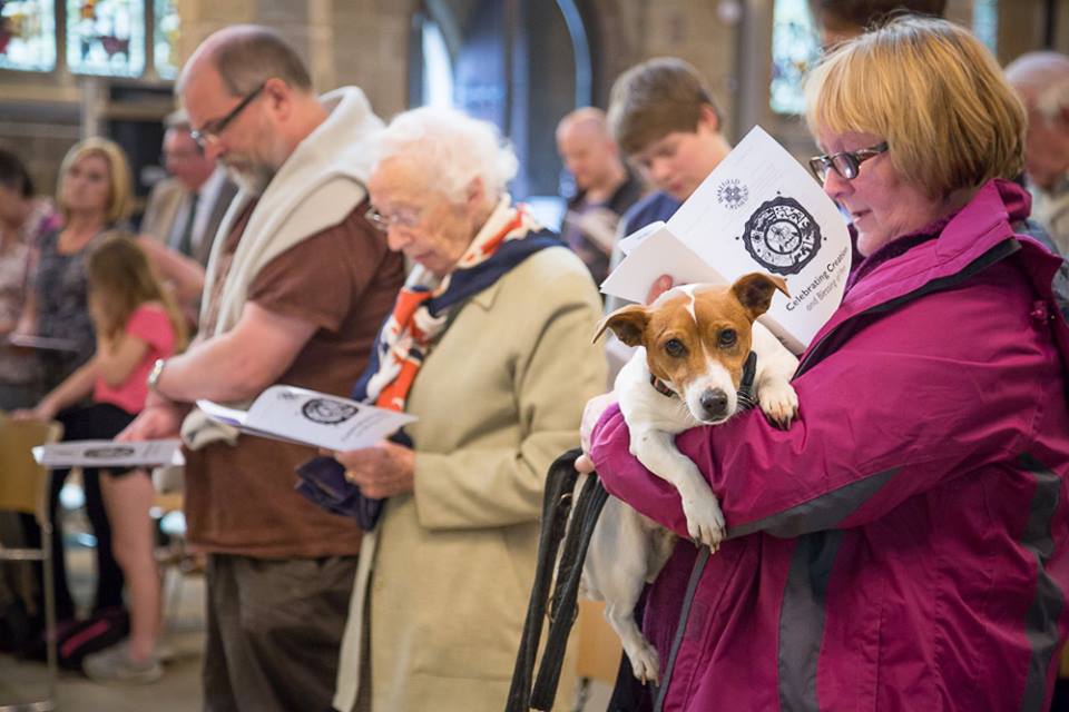 A member of the congregation holding her dog during the service