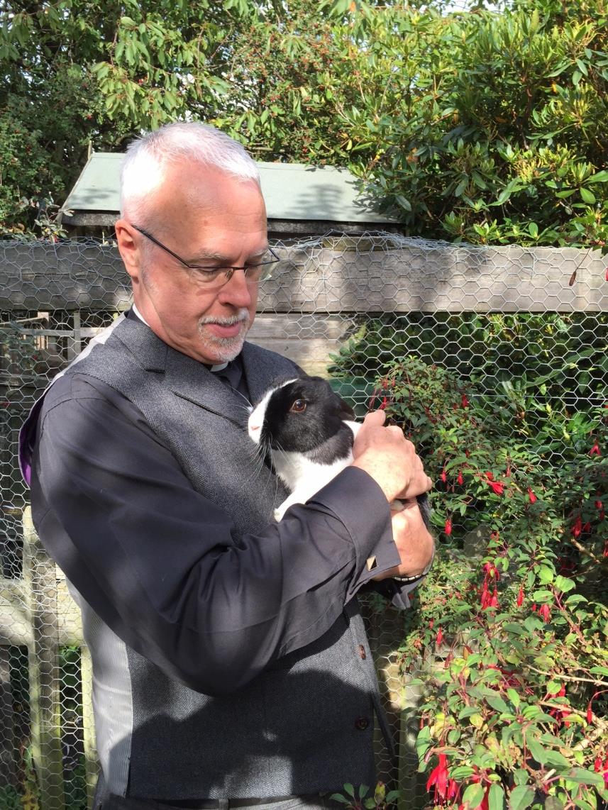 Revd. Jack Parkes, curate of Cleckheaton, holding Sebastian the rabbit 