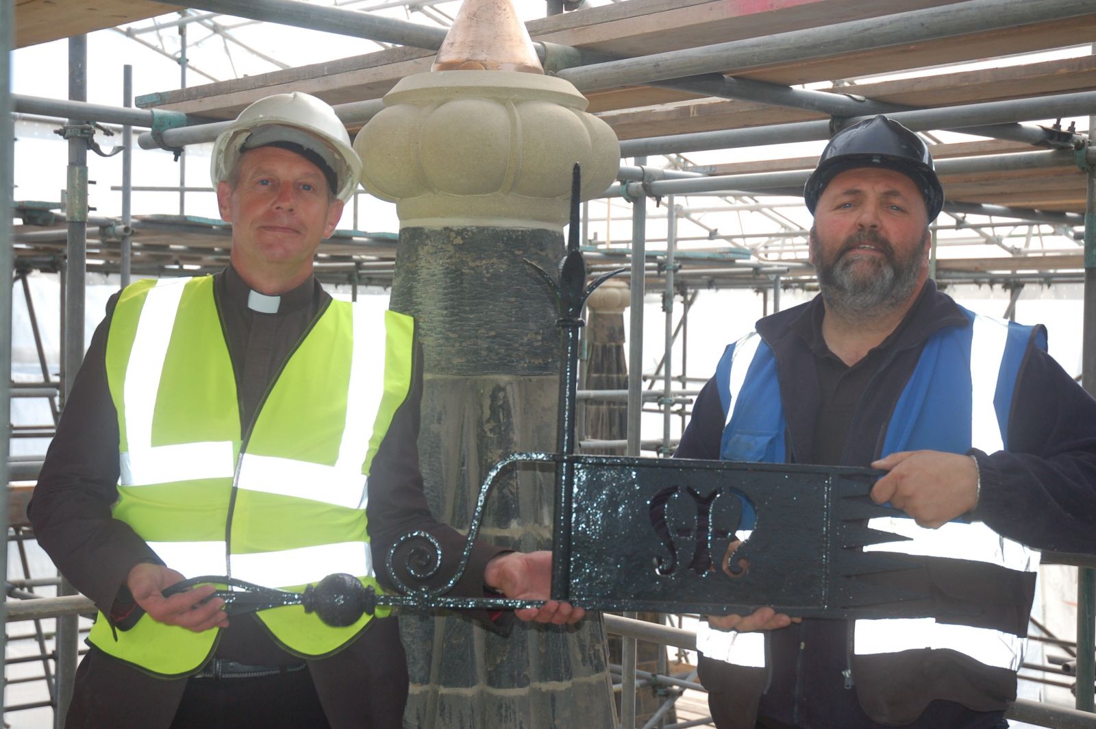 Revd Hugh Baker and Barry Firth with one of the weather vanes