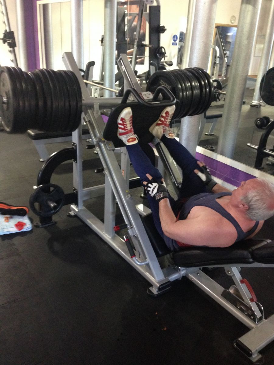 Glenn Stewart pushing weights with his legs to improve his muscle strength