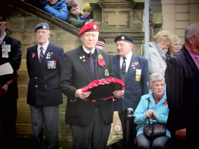 A man laying a wreath at a Remembrance service