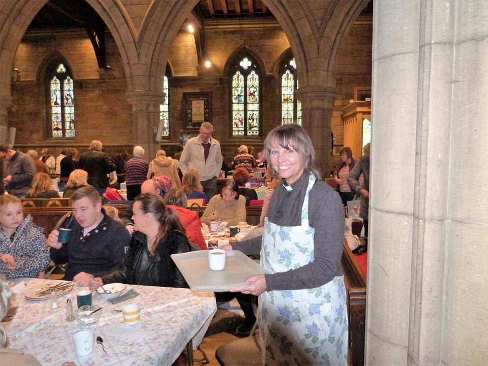 Vicar serving tea at the Bazaar