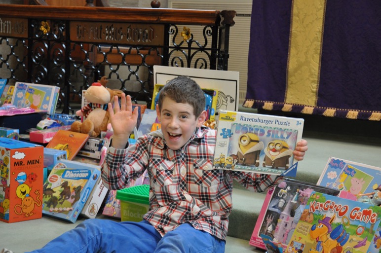 Ivan Sproats, aged 9, member of St John’s congregation, with the toys collected 