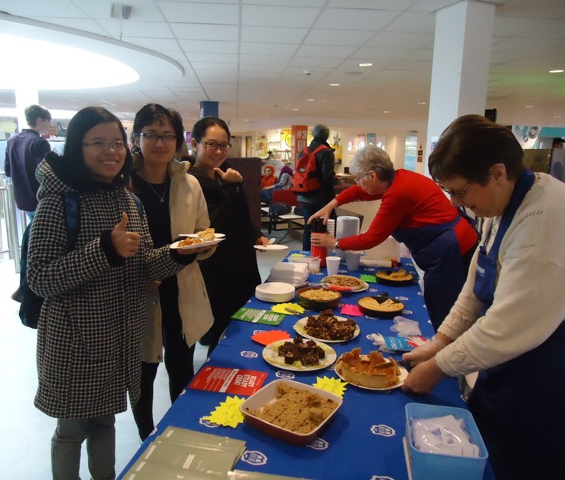 Students taste samples from the Mother's Union recipe book