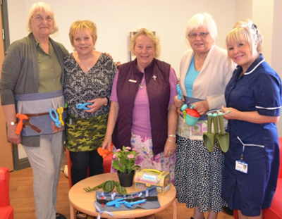 Eileen and other member of the Mothers- Union with the tools and gardening belts